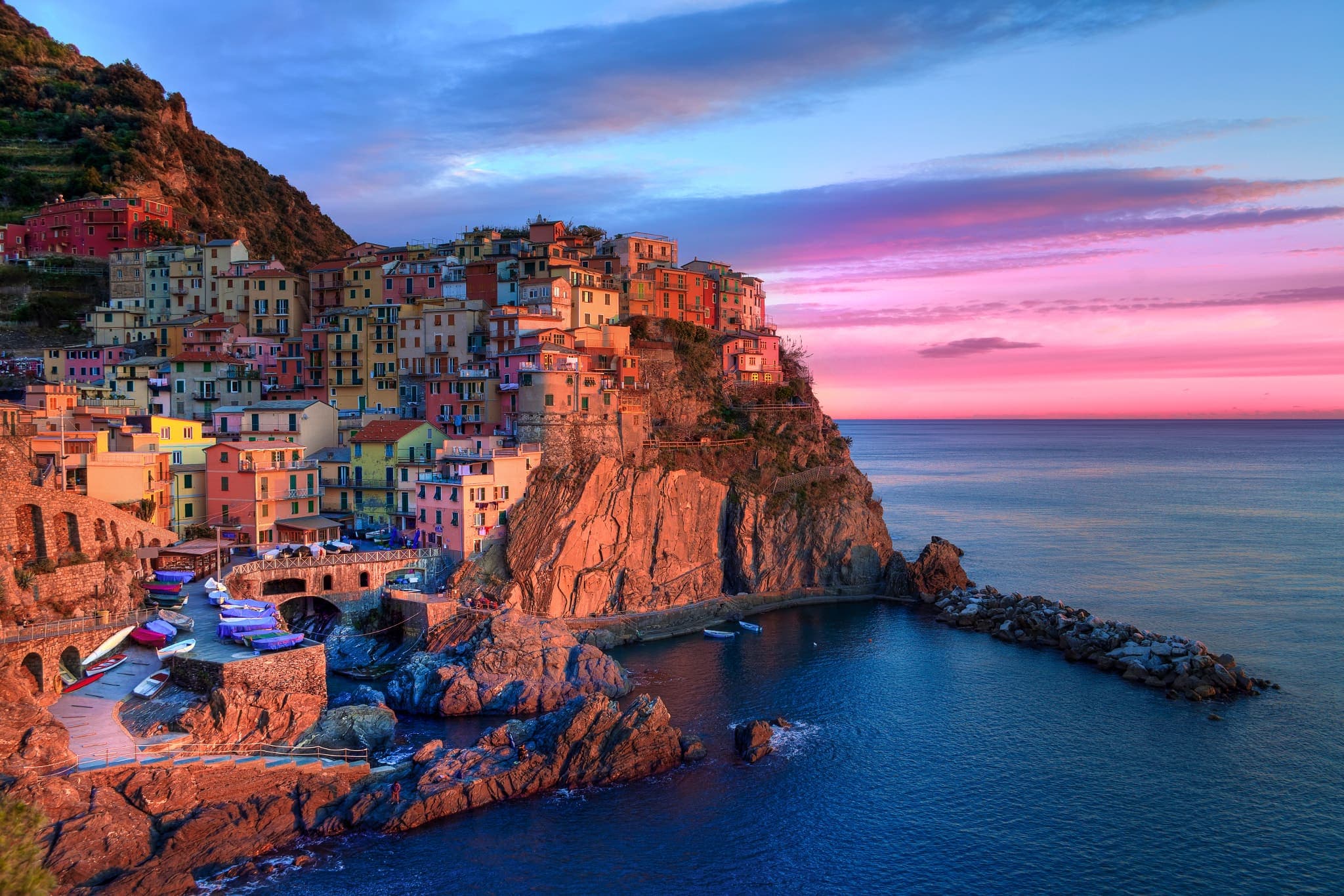 Manarola village on a cliff above the sea at sunset