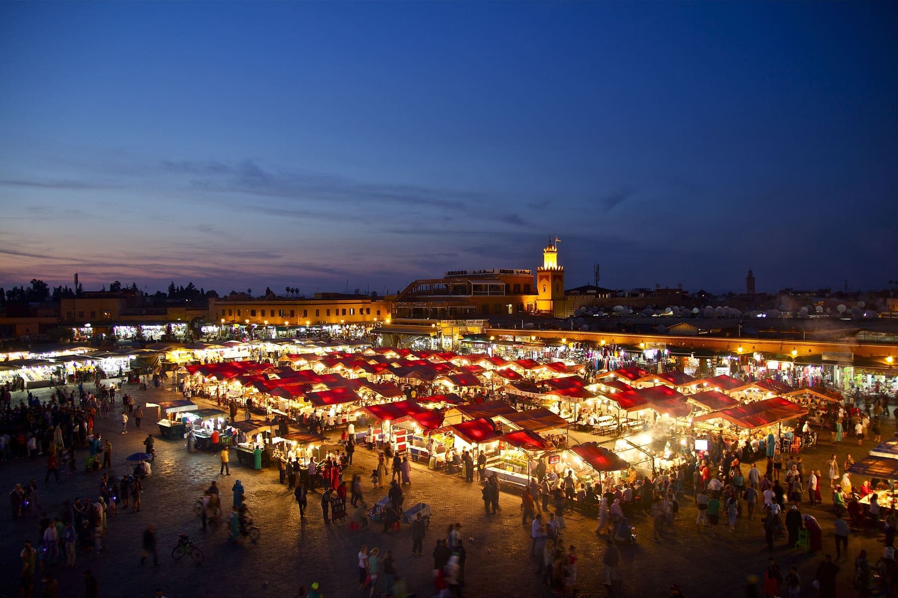 Jemaa el-Fnaa square in Marrakech lit up at dusk