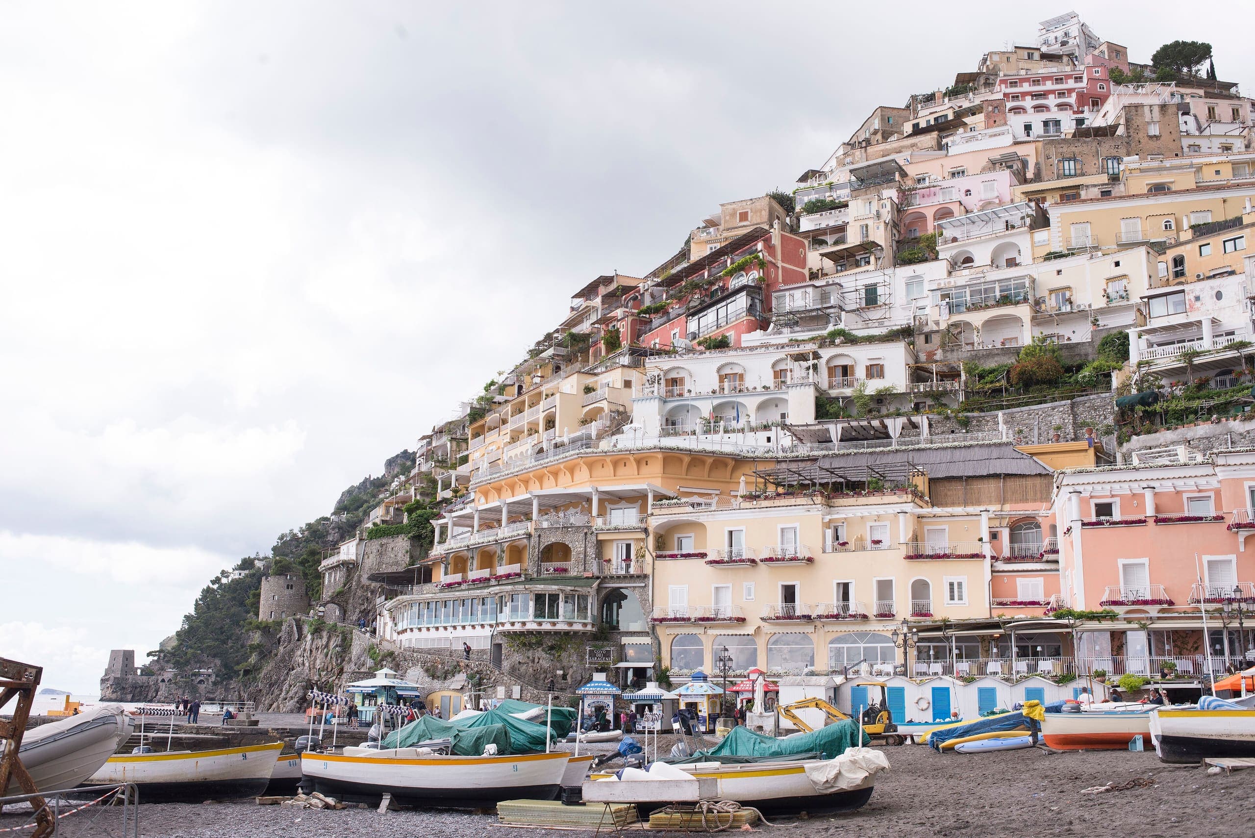 Positano’s pastel houses stacked on the hillside above the beach