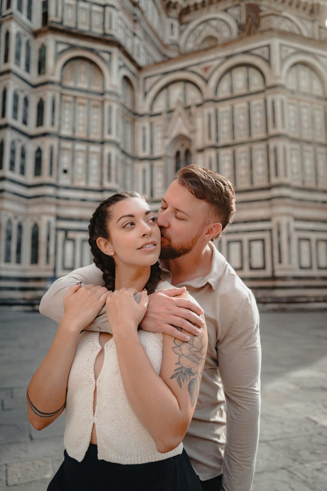 A couple embracing in front of Florence Cathedral on a city trip