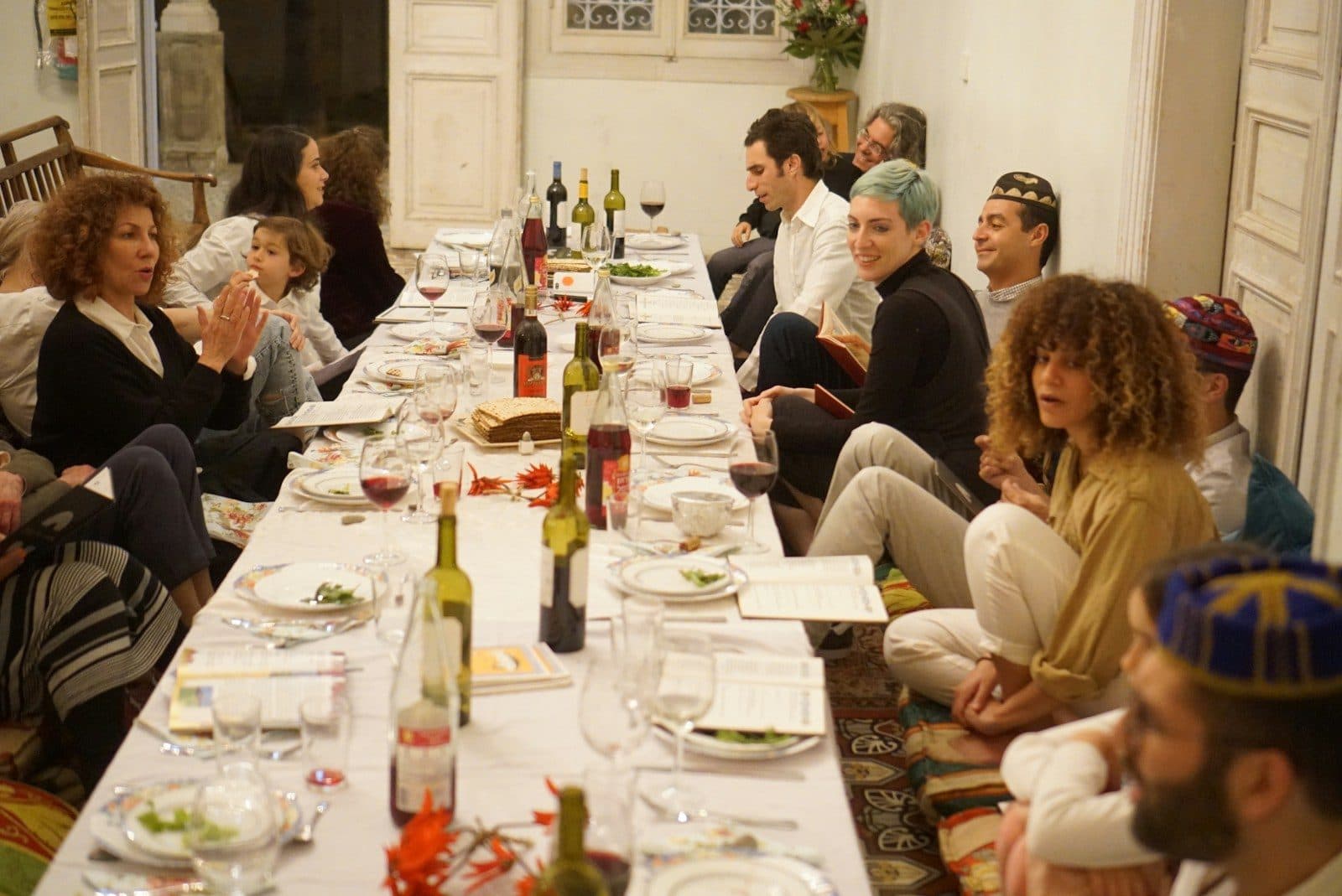 A group of travellers sharing dinner at a long table