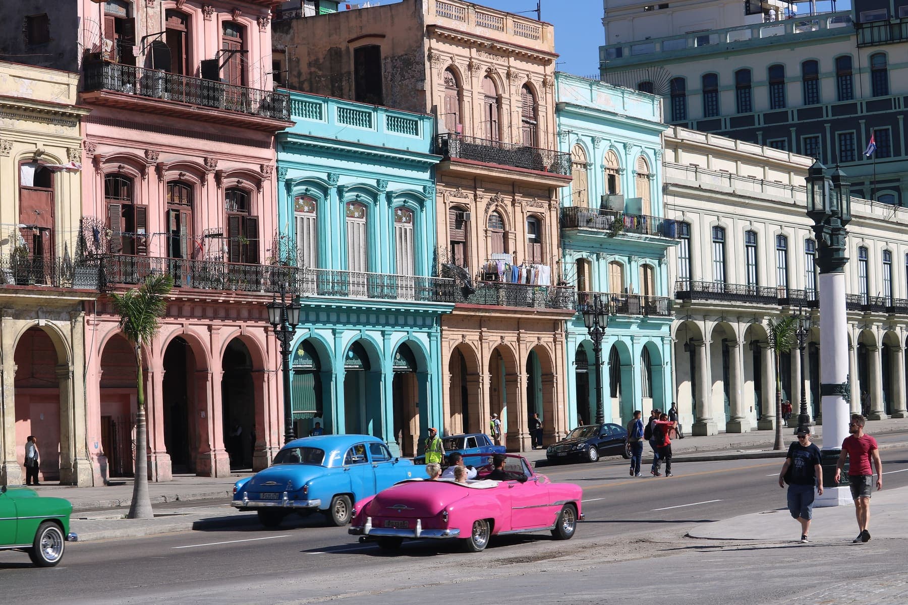 Pastel colonial buildings and classic cars on a Havana street