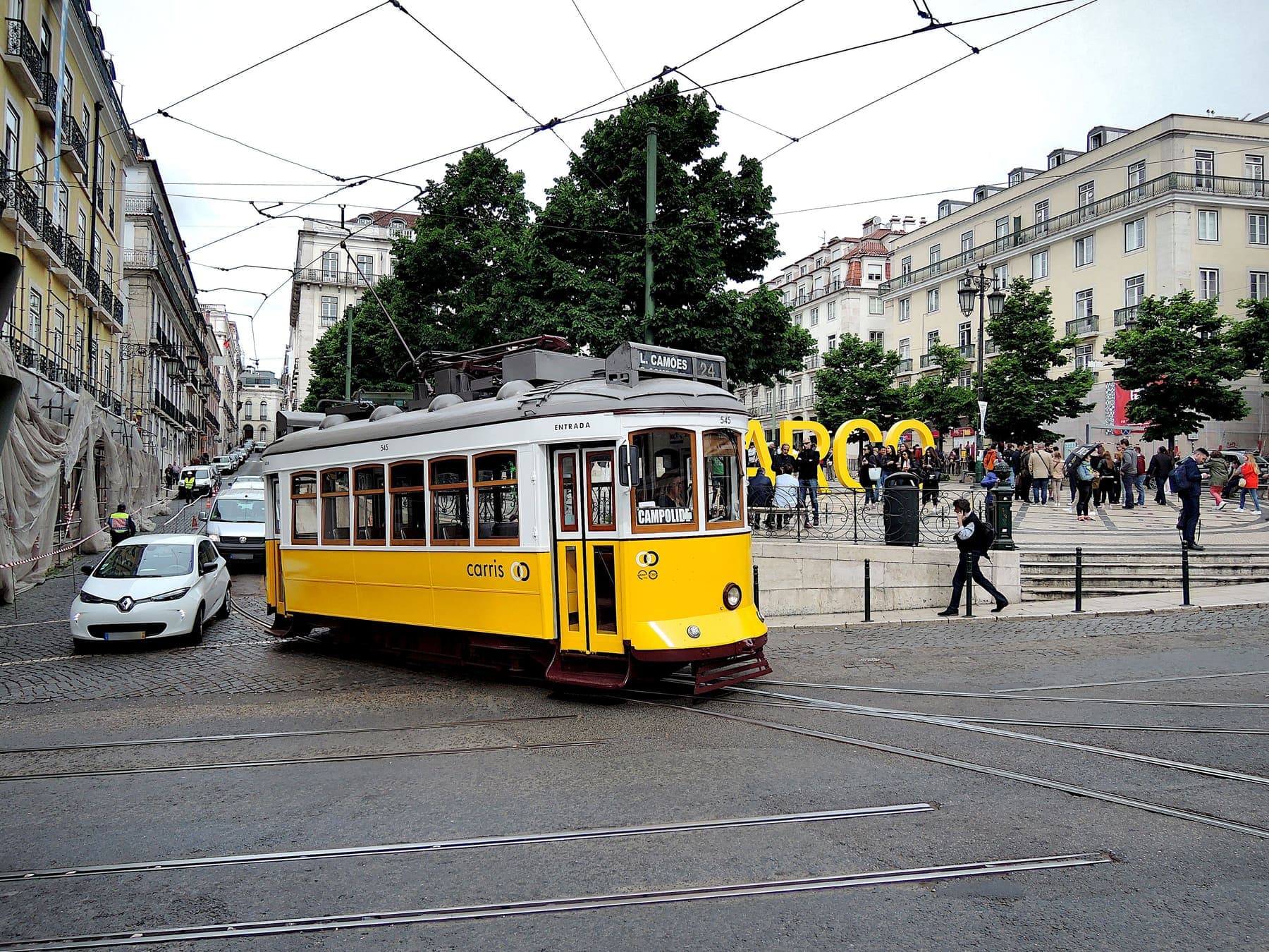 Yellow vintage tram on a sunny Lisbon street