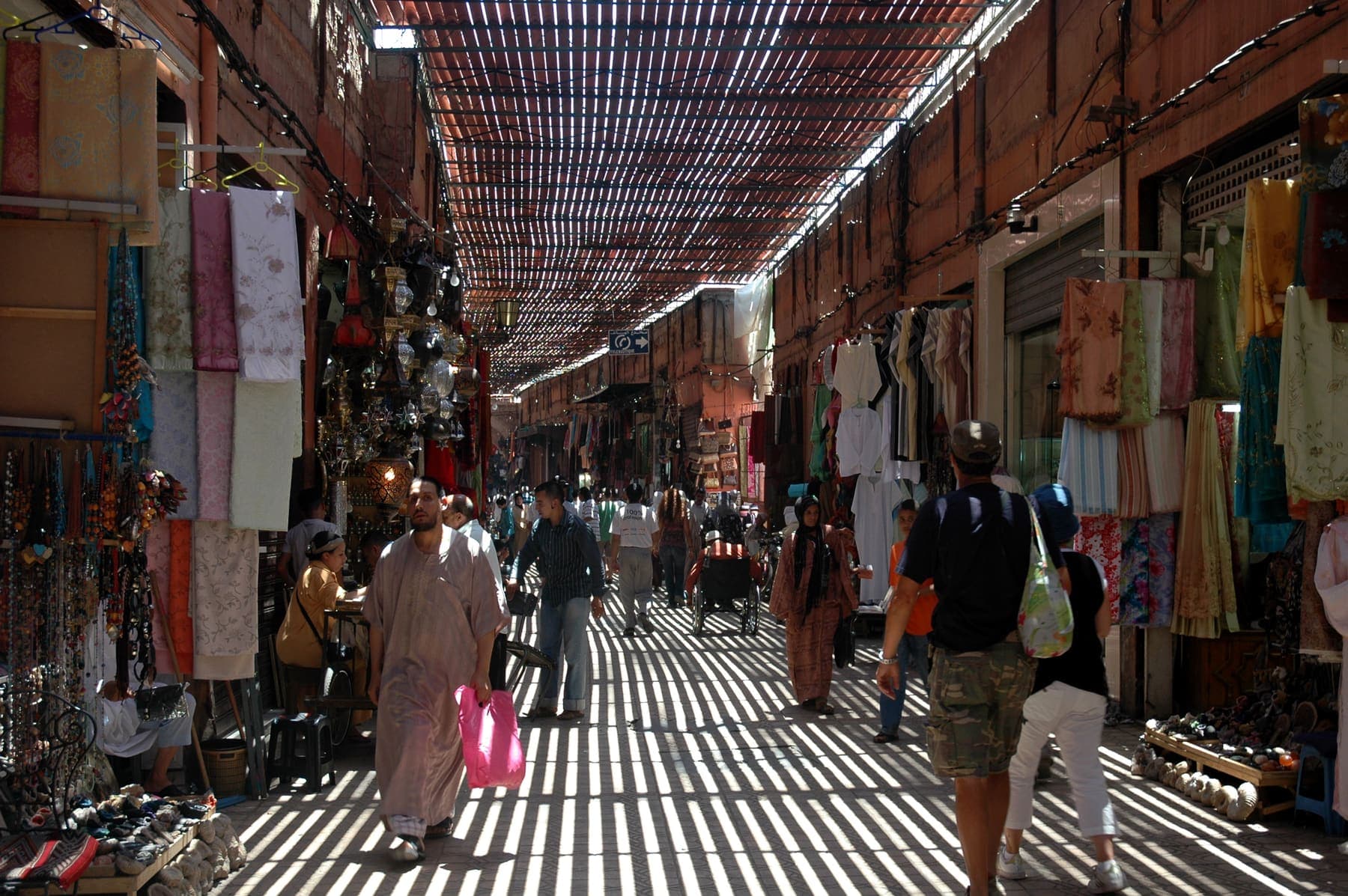 Covered market street with slatted roof light in the Marrakech medina