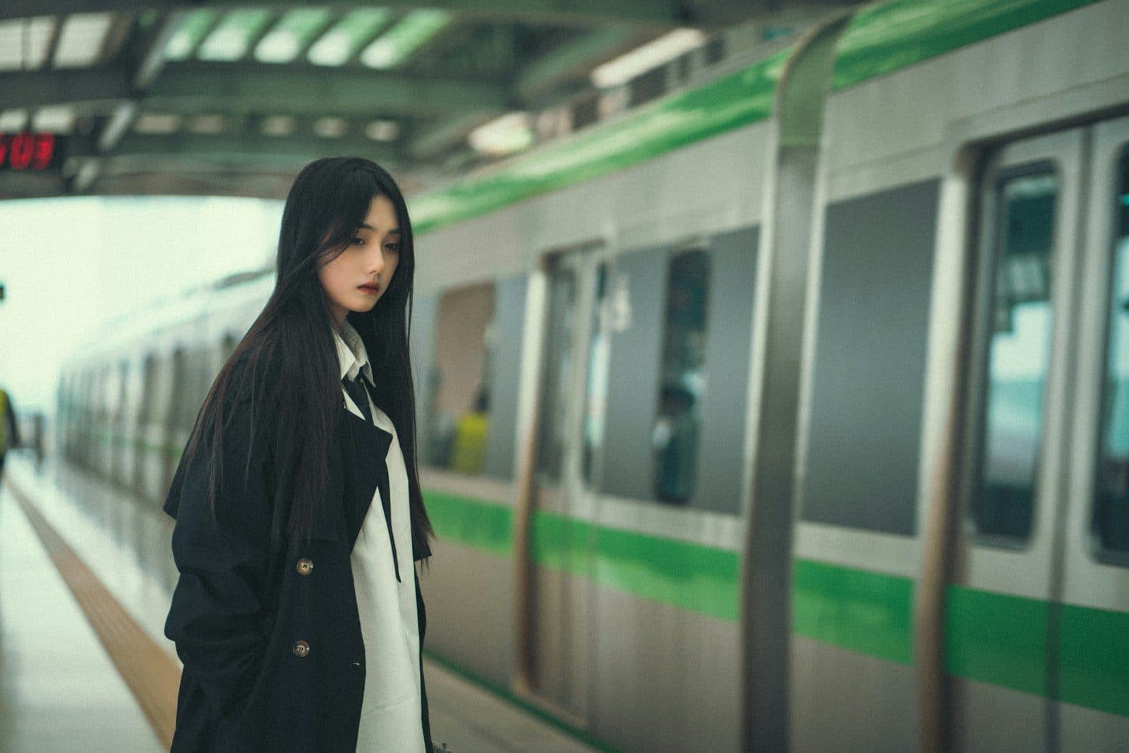 A solo traveller waiting for a train at a station